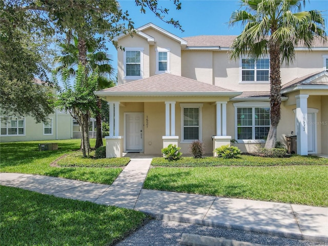 1521 Tranquil Ave, Clermont, FL 34714 - view of front of house with stucco siding, a front lawn, and a shingled roof