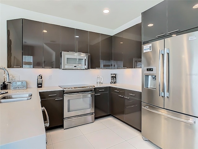 1521 Tranquil Ave, Clermont, FL 34714 - kitchen with appliances with stainless steel finishes, light tile patterned flooring, light countertops, modern cabinets, and recessed lighting
