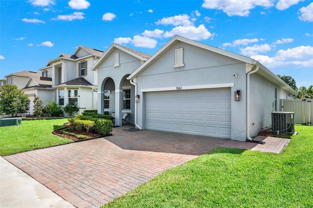 1061 Castlevecchio Loop, Orlando, FL 32825 - traditional-style home featuring stucco siding, a garage, and decorative driveway