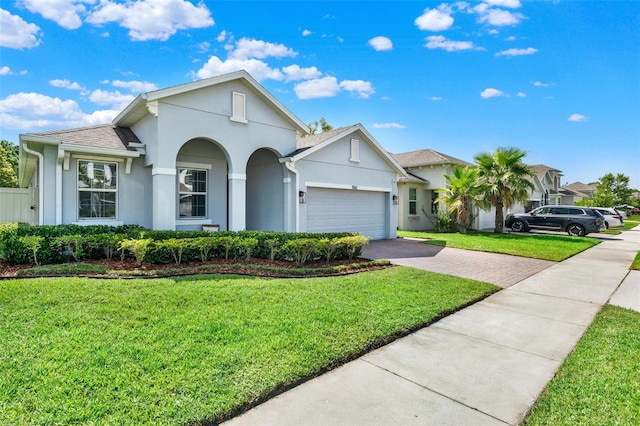 1061 Castlevecchio Loop, Orlando, FL 32825 - view of front facade with stucco siding, decorative driveway, a garage, and a front yard