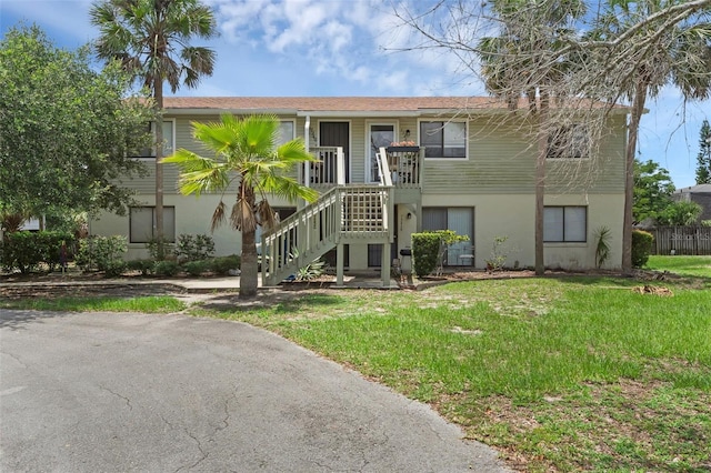 7344 Swallow Run Unit 7344, Winter Park, FL 32792 - view of front of property with a front lawn, stairway, and stucco siding