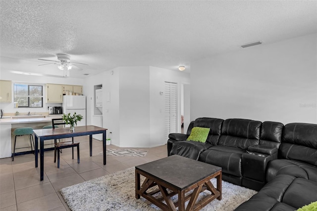 7344 Swallow Run Unit 7344, Winter Park, FL 32792 - living room featuring a textured ceiling, ceiling fan, and light tile patterned floors