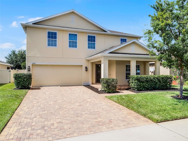 2432 Riviera Ln, Minneola, FL 34715 - view of front facade featuring decorative driveway, stucco siding, and an attached garage