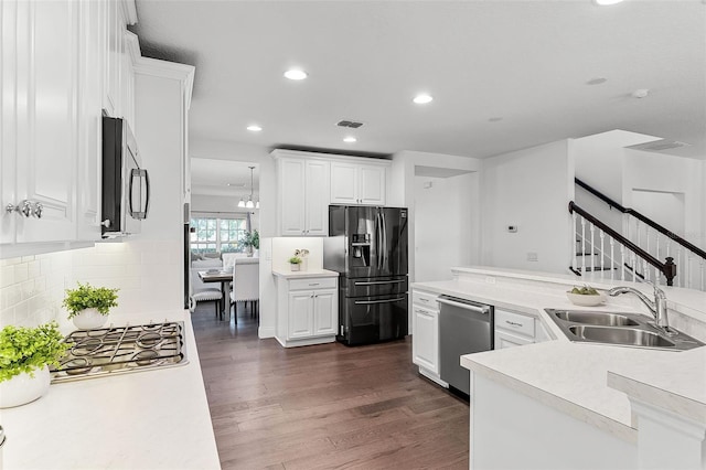2432 Riviera Ln, Minneola, FL 34715 - kitchen featuring appliances with stainless steel finishes, light countertops, dark wood-type flooring, white cabinetry, and recessed lighting