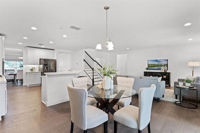 2432 Riviera Ln, Minneola, FL 34715 - dining space featuring a chandelier, wood finished floors, recessed lighting, and stairway
