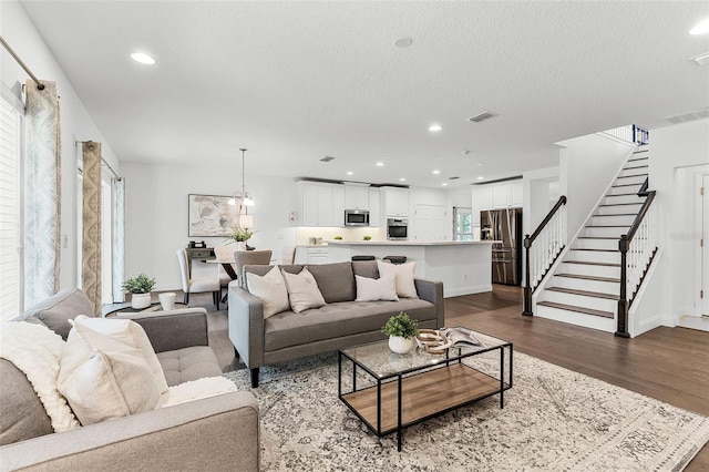 2432 Riviera Ln, Minneola, FL 34715 - living room featuring stairway, healthy amount of natural light, dark wood-style floors, a textured ceiling, and recessed lighting