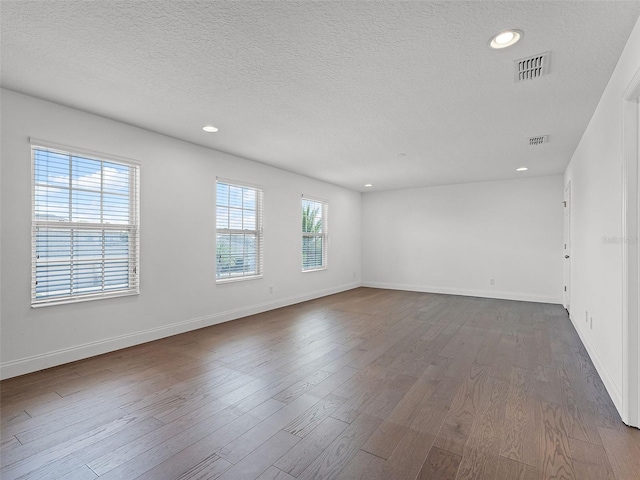 2432 Riviera Ln, Minneola, FL 34715 - spare room with a textured ceiling, recessed lighting, and dark wood-style flooring