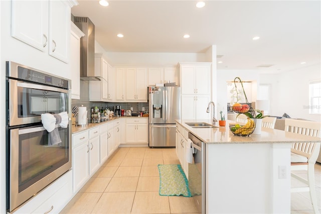 1545 Fairview Cir, Reunion, FL 34747 - kitchen featuring stainless steel appliances, wall chimney range hood, tasteful backsplash, light tile patterned floors, and recessed lighting