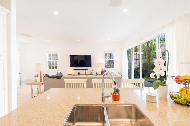 1545 Fairview Cir, Reunion, FL 34747 - kitchen with recessed lighting, light stone counters, open floor plan, and tile patterned floors