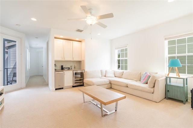 1545 Fairview Cir, Reunion, FL 34747 - living area featuring wine cooler, wet bar, light colored carpet, ceiling fan, and recessed lighting