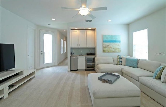 1545 Fairview Cir, Reunion, FL 34747 - living area with beverage cooler, bar with sink, light colored carpet, a ceiling fan, and recessed lighting