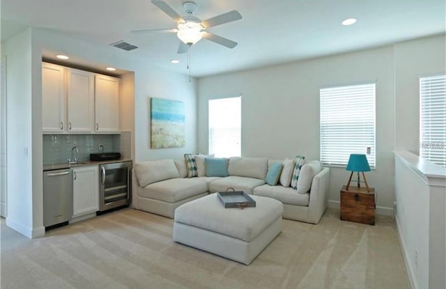 1545 Fairview Cir, Reunion, FL 34747 - living room featuring beverage cooler, bar with sink, light colored carpet, healthy amount of natural light, and recessed lighting