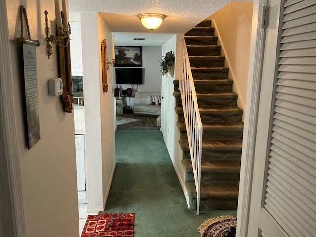 1409 Oak Pl Unit F, Apopka, FL 32712 - hallway with carpet, stairway, and a textured ceiling