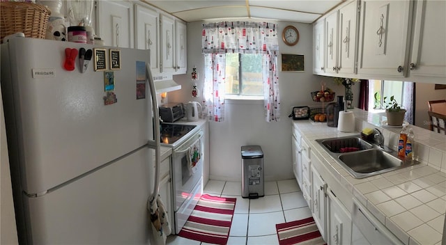 1409 Oak Pl Unit F, Apopka, FL 32712 - kitchen with white appliances, tile countertops, and plenty of natural light