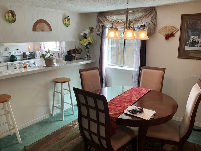 1409 Oak Pl Unit F, Apopka, FL 32712 - dining room featuring a textured ceiling and dark carpet