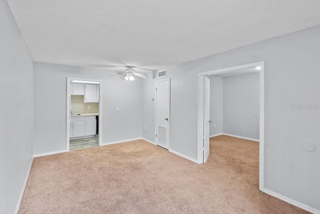 2517 Caper Ln Unit 207, Maitland, FL 32751 - spare room featuring light carpet, ceiling fan, and a textured ceiling