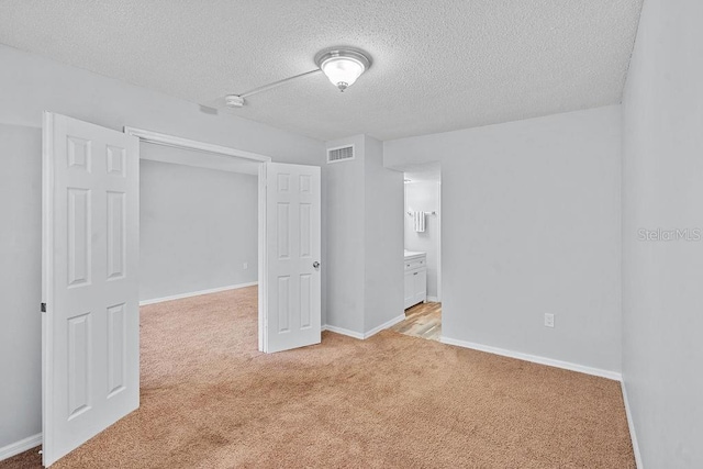 2517 Caper Ln Unit 207, Maitland, FL 32751 - unfurnished room featuring light carpet, a textured ceiling, and a smoke detector