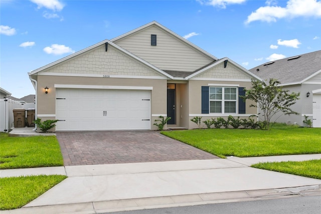 5808 Arboretum St, Saint Cloud, FL 34771 - view of front of property featuring decorative driveway, a front lawn, a garage, and stucco siding