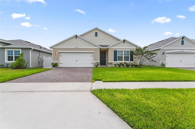 5808 Arboretum St, Saint Cloud, FL 34771 - view of front of house featuring driveway, an attached garage, a front yard, stucco siding, and a gate