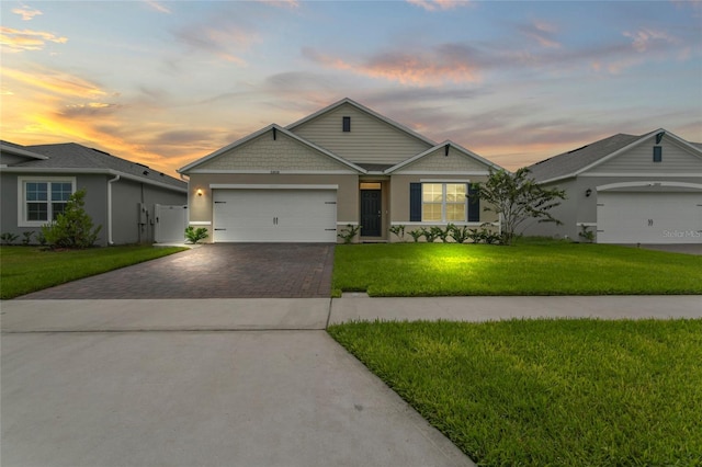 5808 Arboretum St, Saint Cloud, FL 34771 - view of front facade featuring driveway, a front yard, an attached garage, and stucco siding