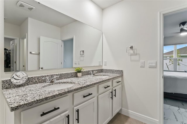 5808 Arboretum St, Saint Cloud, FL 34771 - full bath with double vanity, ensuite bath, and marble look tiles