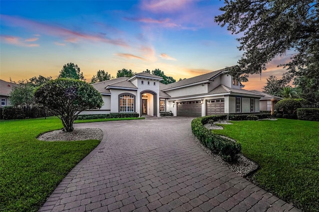 3316 Regal Crest Dr, Longwood, FL 32779 - view of front of home featuring decorative driveway, a garage, stucco siding, and a yard