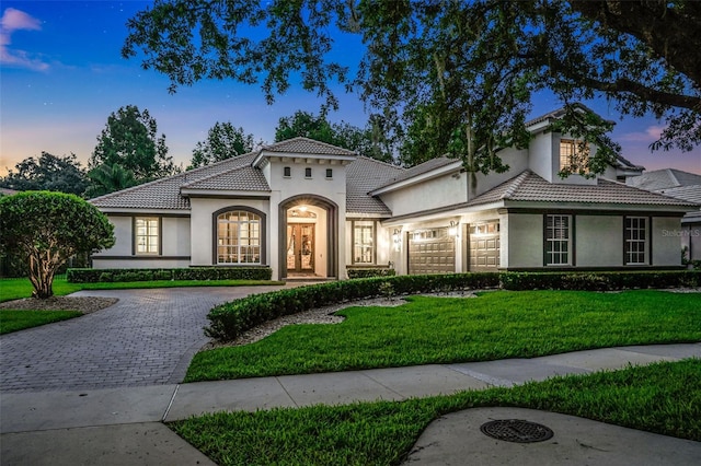 3316 Regal Crest Dr, Longwood, FL 32779 - mediterranean / spanish-style home featuring stucco siding, driveway, an attached garage, and a yard