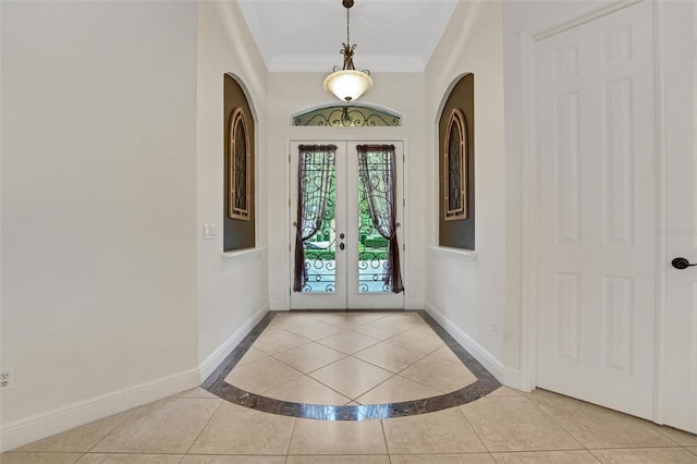 3316 Regal Crest Dr, Longwood, FL 32779 - tiled entryway featuring french doors, crown molding, inlaid floor details, and arched walkways