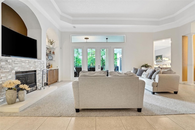 3316 Regal Crest Dr, Longwood, FL 32779 - living room with light colored carpet, a raised ceiling, ornamental molding, a fireplace, and light tile patterned floors