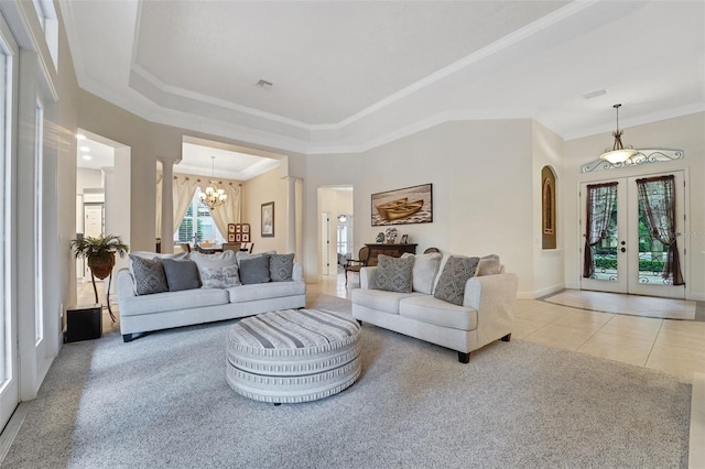 3316 Regal Crest Dr, Longwood, FL 32779 - tiled living area featuring french doors, a chandelier, crown molding, a tray ceiling, and carpet