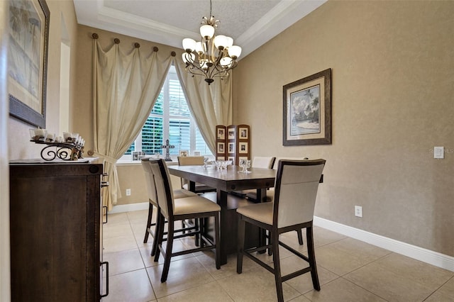 3316 Regal Crest Dr, Longwood, FL 32779 - dining area featuring a chandelier, a tray ceiling, light tile patterned floors, and crown molding