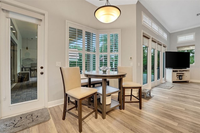 3316 Regal Crest Dr, Longwood, FL 32779 - dining area with light wood-style flooring and ornamental molding
