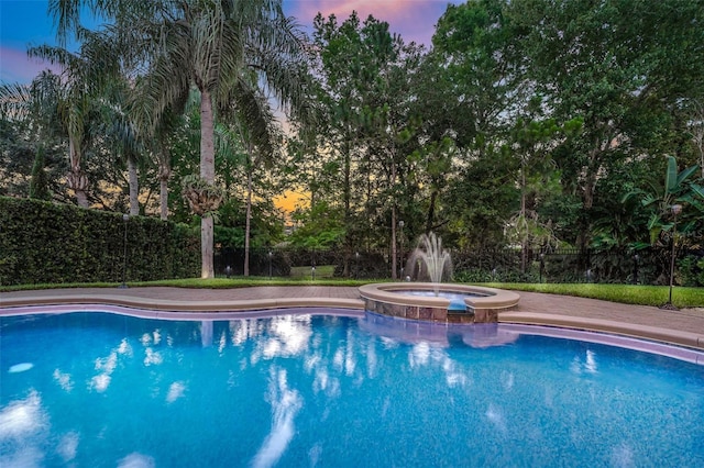 3316 Regal Crest Dr, Longwood, FL 32779 - pool at dusk with a pool with connected hot tub