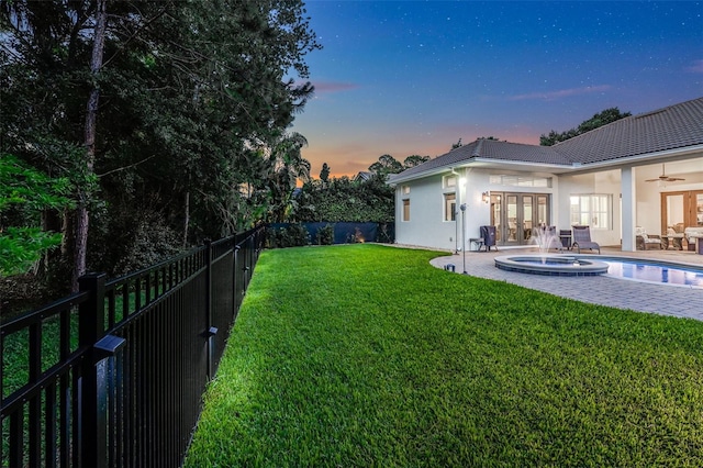 3316 Regal Crest Dr, Longwood, FL 32779 - yard at dusk with french doors, ceiling fan, a fenced backyard, and a patio area