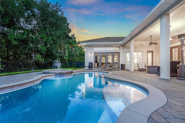 3316 Regal Crest Dr, Longwood, FL 32779 - pool at dusk with french doors, a patio area, ceiling fan, and a pool with connected hot tub