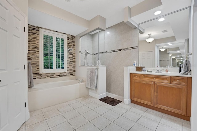 3316 Regal Crest Dr, Longwood, FL 32779 - bathroom featuring tile patterned flooring, a garden tub, vanity, and a walk in shower