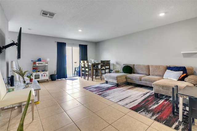 509 Cresting Oak Cir Unit 73, Orlando, FL 32824 - living area featuring tile patterned floors, a textured ceiling, and recessed lighting