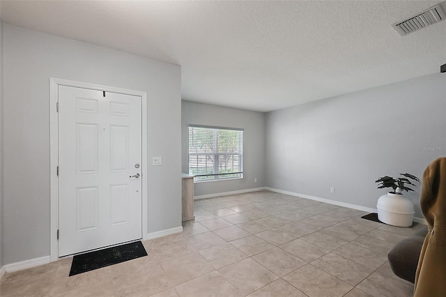 1292 Cavender Creek Rd, Minneola, FL 34715 - entrance foyer featuring a textured ceiling and light tile patterned floors