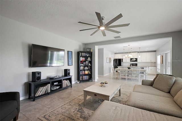 1292 Cavender Creek Rd, Minneola, FL 34715 - living room featuring ceiling fan, light tile patterned floors, and a chandelier