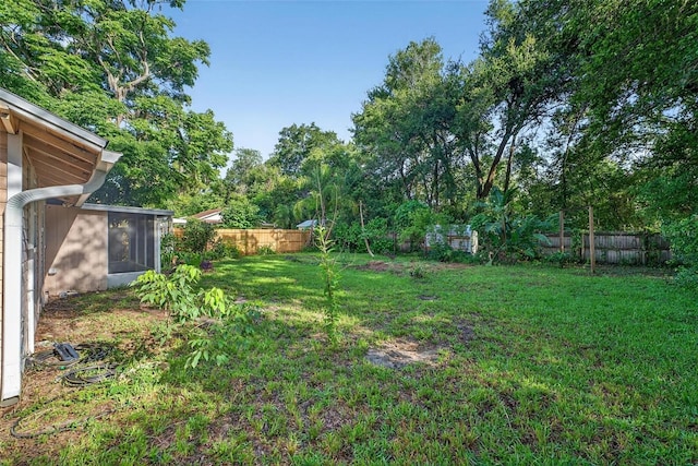 815 E 11th Ave, Mount Dora, FL 32757 - fenced backyard with a sunroom and view of scattered trees