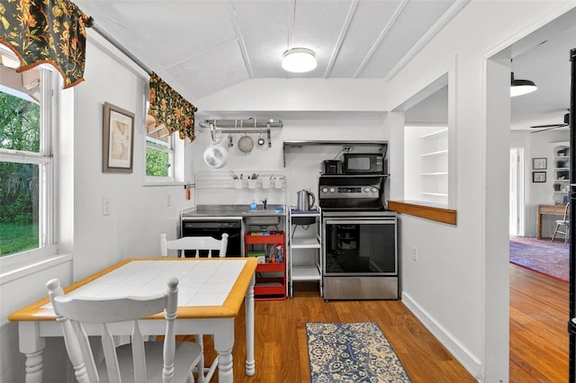 815 E 11th Ave, Mount Dora, FL 32757 - kitchen with black appliances, lofted ceiling, wood finished floors, tile counters, and ceiling fan