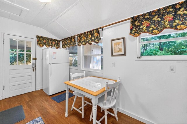 815 E 11th Ave, Mount Dora, FL 32757 - dining area with vaulted ceiling, wood finished floors, and plenty of natural light