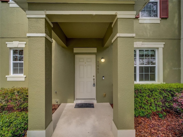 7462 Bentonshire Ave, Windermere, FL 34786 - doorway to property with stucco siding