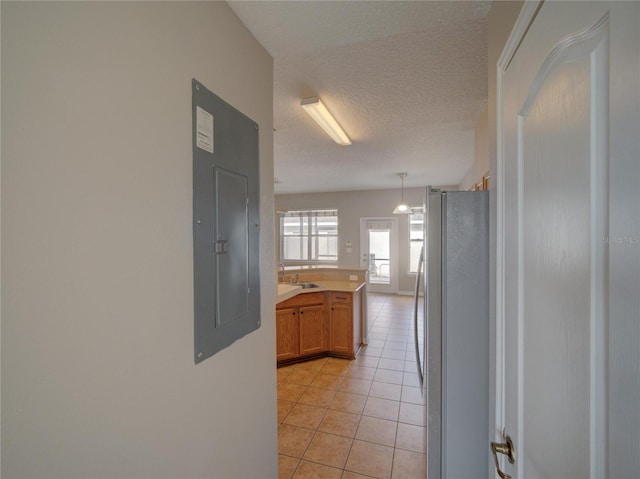 7462 Bentonshire Ave, Windermere, FL 34786 - hall featuring light tile patterned floors, a textured ceiling, and electric panel