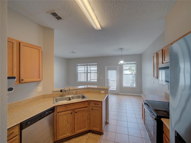 7462 Bentonshire Ave, Windermere, FL 34786 - kitchen featuring appliances with stainless steel finishes, a peninsula, light countertops, light tile patterned flooring, and a textured ceiling