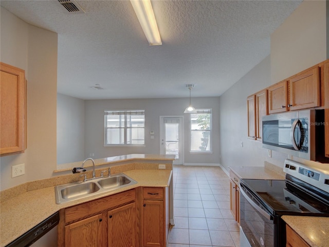 7462 Bentonshire Ave, Windermere, FL 34786 - kitchen with appliances with stainless steel finishes, a peninsula, light countertops, a textured ceiling, and light tile patterned flooring