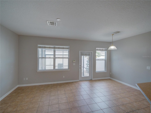 7462 Bentonshire Ave, Windermere, FL 34786 - spare room with a textured ceiling and light tile patterned floors