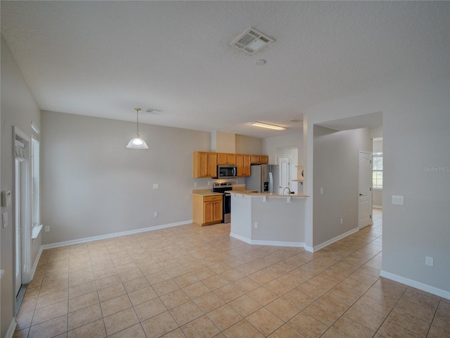 7462 Bentonshire Ave, Windermere, FL 34786 - kitchen featuring stainless steel appliances, light countertops, open floor plan, and light tile patterned floors