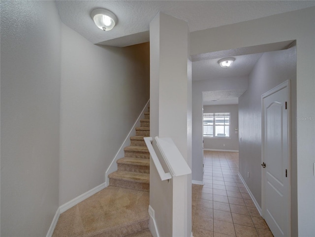 7462 Bentonshire Ave, Windermere, FL 34786 - stairway with a textured ceiling and tile patterned flooring