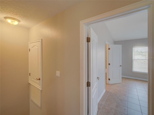 7462 Bentonshire Ave, Windermere, FL 34786 - corridor with light tile patterned flooring, a textured ceiling, and vaulted ceiling